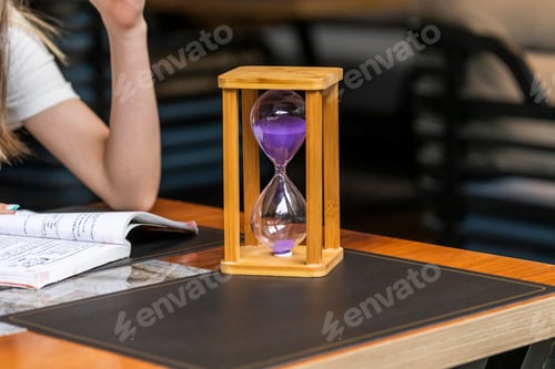 Preview: Photo of wooden hourglass on the table