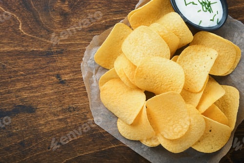 Preview: Potato corrugatedchips. Fast food. Crispy potato chips ceramic black bowl with sour cream sauce and
