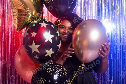 Preview: Beautiful black woman enjoying a party lifestyle. Birthday party, clubbing and holidays concept