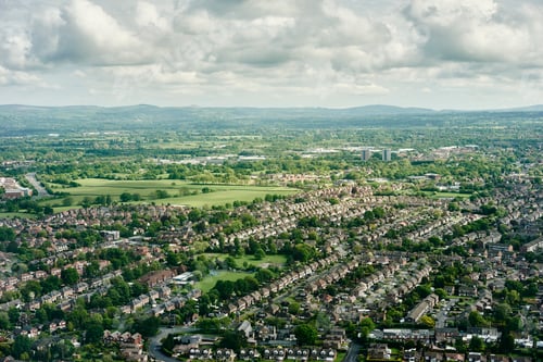 Preview: Aerial view of suburban housing and distant landscape, England, UK