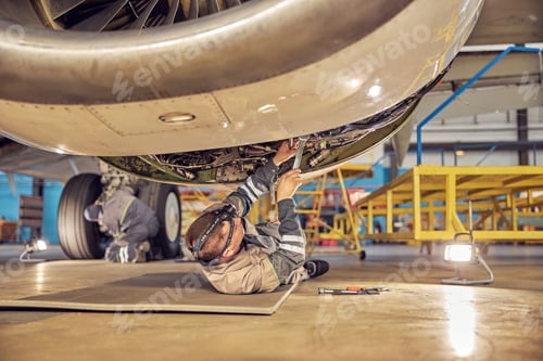 Preview: Mechanic installing reverse hoods in the hangar