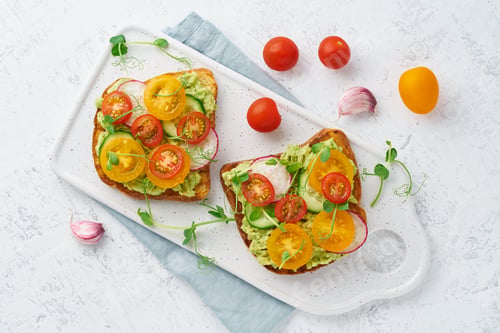 Preview: avocado toast with cherry tomatoes and herbs, breakfast, top view
