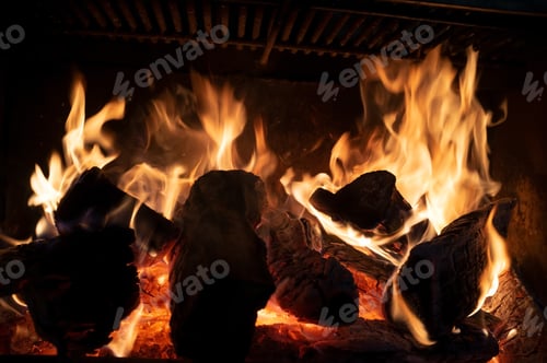 Preview: Fire and burning firewood in an iron fireplace to heat a house during an energy crisis