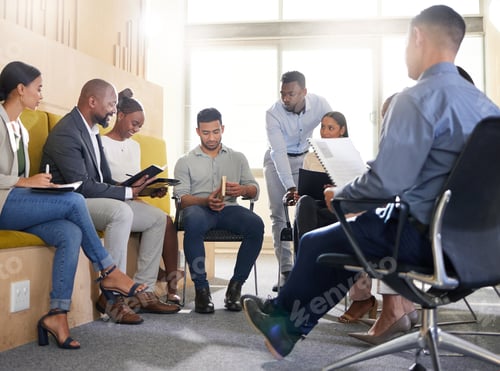 Preview: Cropped shot of a diverse group of businesspeople sitting in the boardroom during a meeting