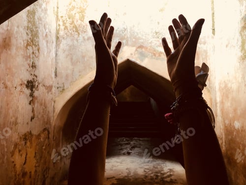 Preview: Woman Holding Arms Hands In Praying Position In A Sacred Place.