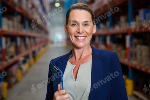 Preview: Business woman smiling with her clipboard