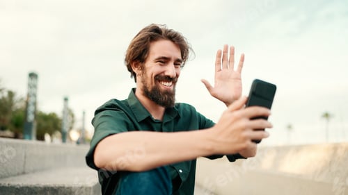 Preview: Closeup of a young hipster man using a mobile phone