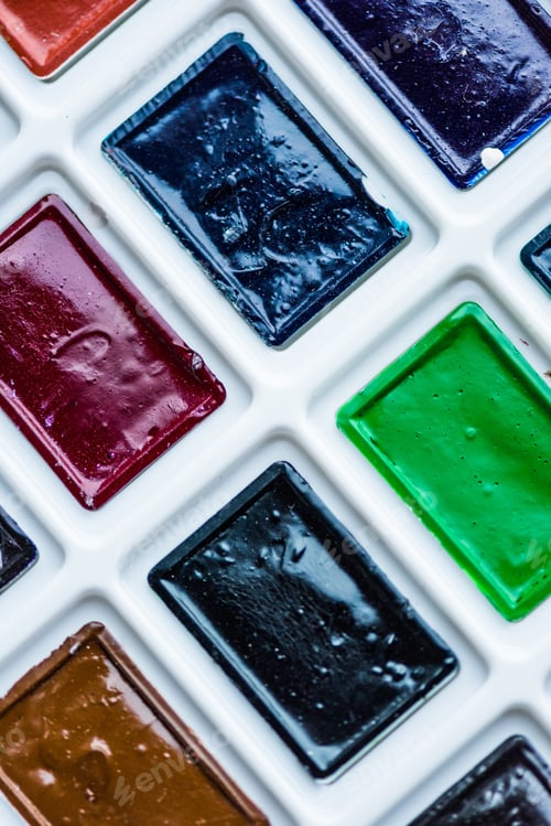 Preview: Close-up view of set of colorful paint in plastic white box