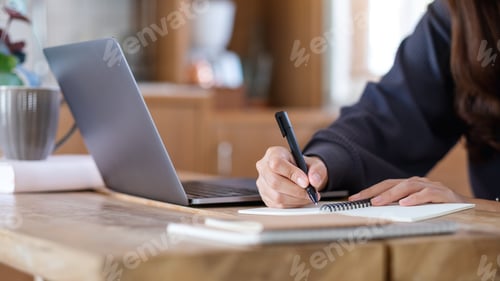 Preview: A woman using laptop computer for working or studying online at home