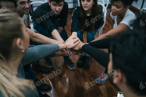 Preview: Team of work showing unity with their hand together.