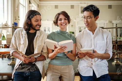 Preview: Group of young casual multinational students joyfully studying making notes in library of university