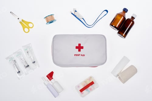 Preview: flat lay with automotive first aid kit with various medicines isolated on white