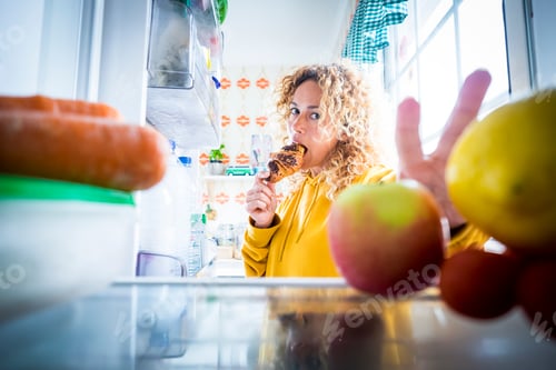 Preview: Alternaive inside view of Beautiful hungry adult woman from fridge