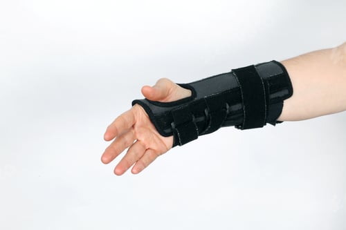 Preview: Closeup shot of a hand in an orthopedic medical fitness wrist bandage