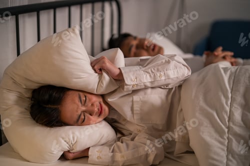 Preview: Asian woman feel frustrated from husband snoring while sleep at night.