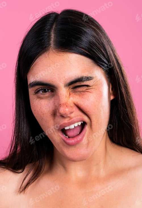 Preview: Young woman expressing playful emotion on pink background