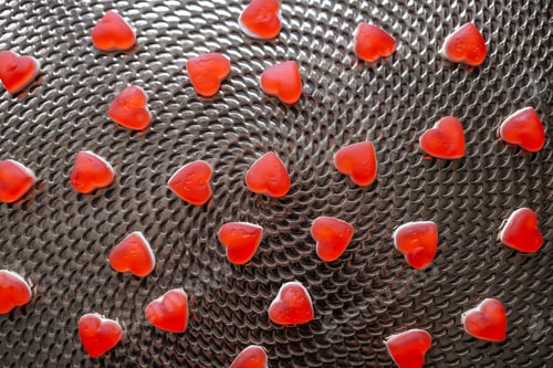 Preview: Candies in the form of a red heart on the table