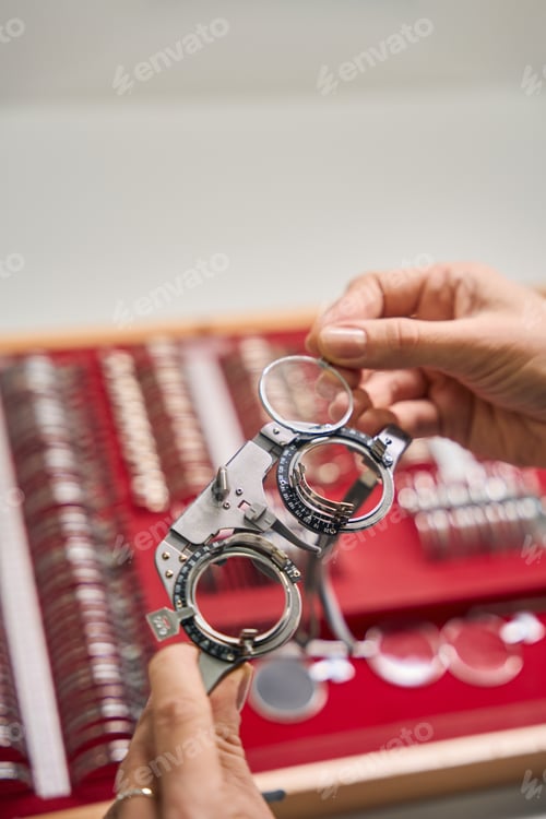 Preview: Hand holding a trial frame for lens testing