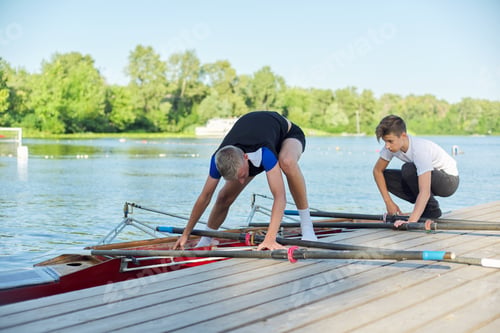 Preview: Team of two teenage boys kayaking on river
