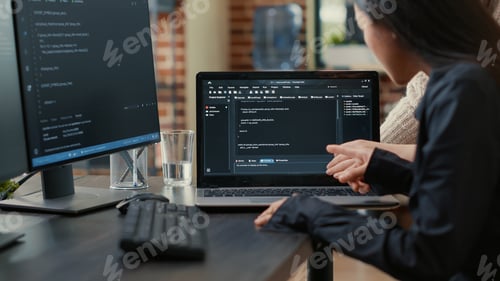 Preview: Team of programmers talking about algorithm running on laptop screen pointing at source code