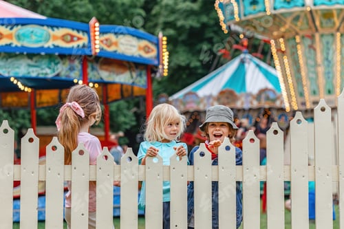Preview: brothers and sister standing by the fence at the summer fair