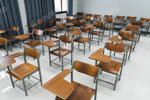 Preview: School classroom with many wooden chairs well-arranged in rows with no student