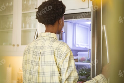 Preview: Woman opening the fridge