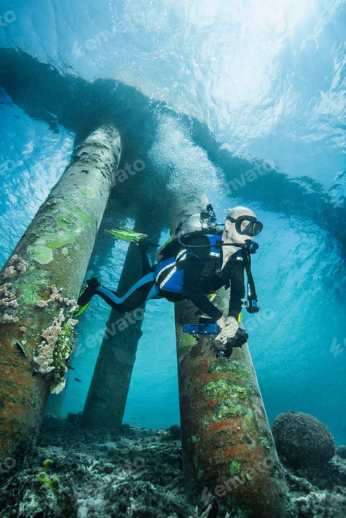 Preview: Diver examining underwater shipwreck