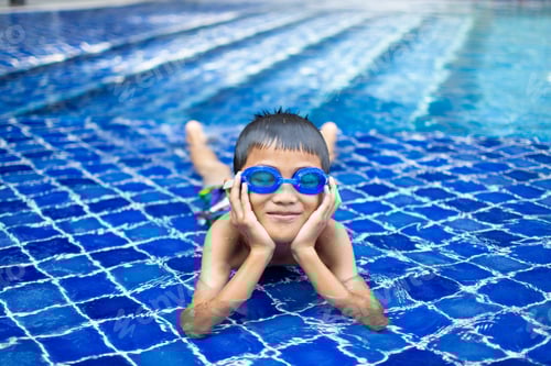 Preview: cute little boy feel happy play and swimming at swimming pool , sunny day and soft focus.