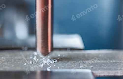 Preview: Drilling process with shavings close-up at the workplace in workshop