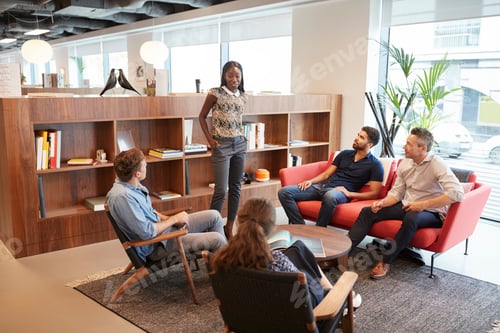 Preview: Casually Dressed Businessmen And Businesswomen Having Informal Meeting In Modern Office