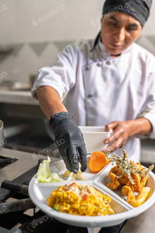 Preview: Chef finishing plating gourmet seafood dish in restaurant kitchen