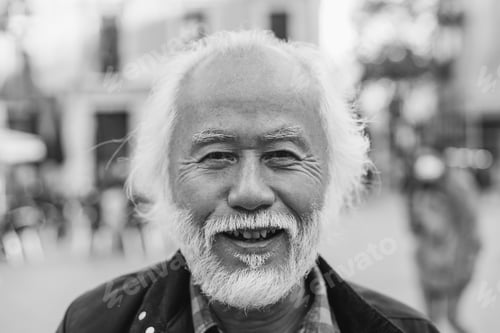 Preview: Asian senior man smiling on camera outdoor - Joyful elderly lifestyle concept