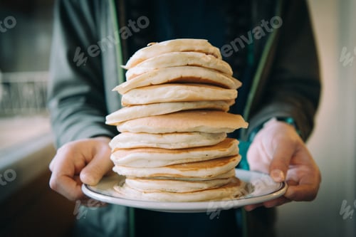Preview: Girl holding a stack of pancakes