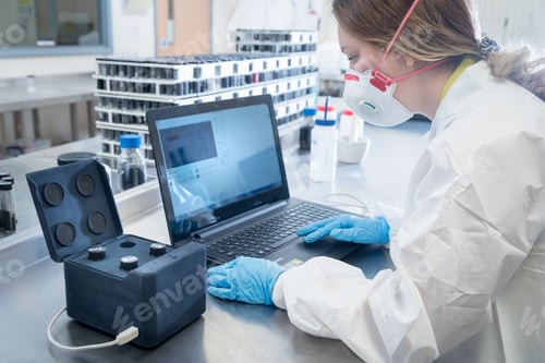 Preview: Scientist with dispersion analysis machine in graphene processing factory
