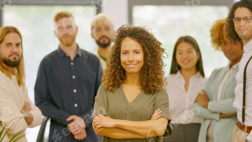 Preview: Woman leading a group of coworkers standing proud