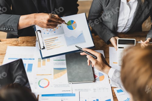 Preview: Business Meeting Analyzing Charts and Graphs Together