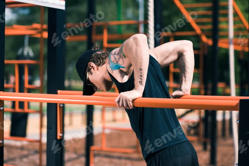 Preview: side view of sportive man exercising on sports ground