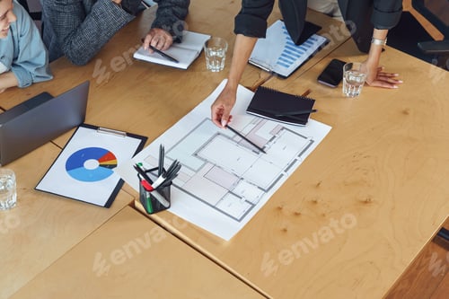 Preview: Close up of professional team design engineers working with project documents in modern office