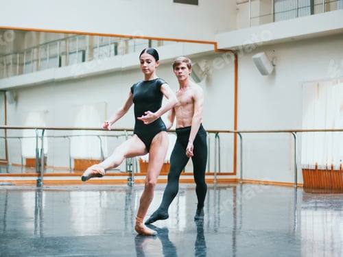 Preview: Man practicing in ballet with partner ballerina woman in black clothing in gym