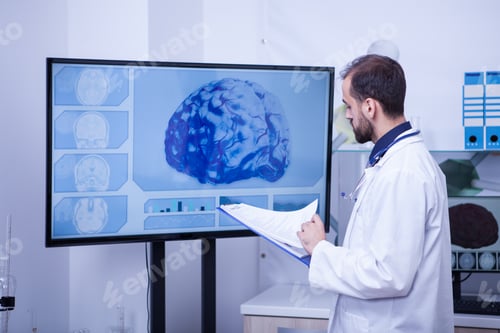 Preview: Doctor checking the brain analyzes of a patient on his clipboard