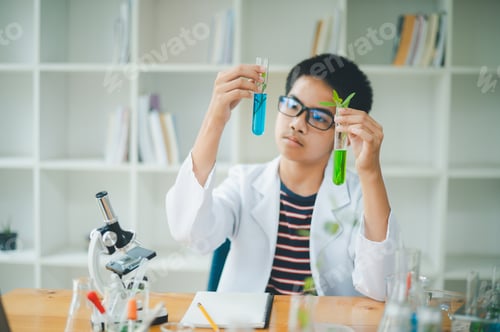 Preview: Asian male science students looking through a microscope and tests of plants