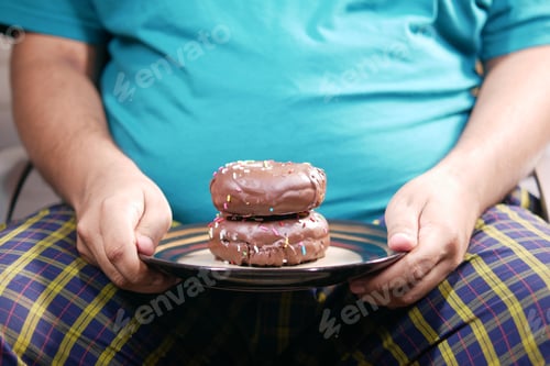 Preview: young man eating donut , selective focus