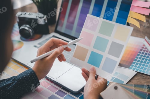 Preview: Graphic designer architects who work with laptops and color comparison tables for design work.