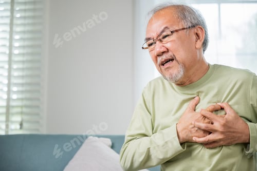 Preview: Sad senior man feeling bad pain use hand touching chest having heart attack