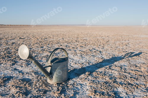 Preview: Watering can on salt flat or sand.