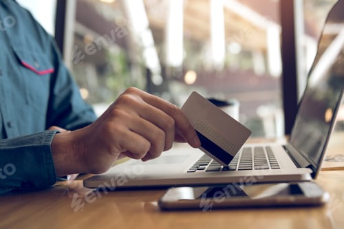 Preview: Man using credit card with shopping online concept at cafe.