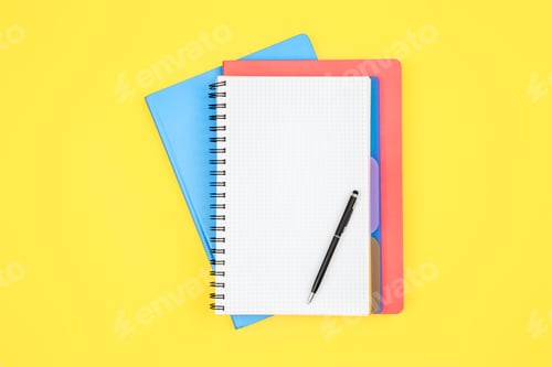 Preview: Notebooks and pen on a yellow background, top view.