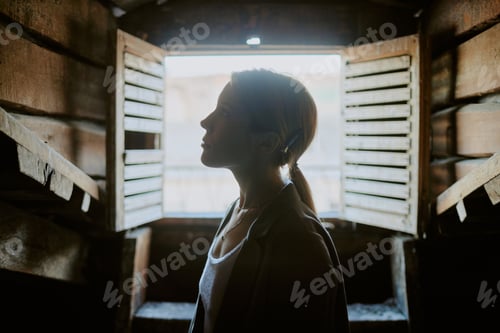 Preview: Woman Standing in Front of Open Wooden Shutters