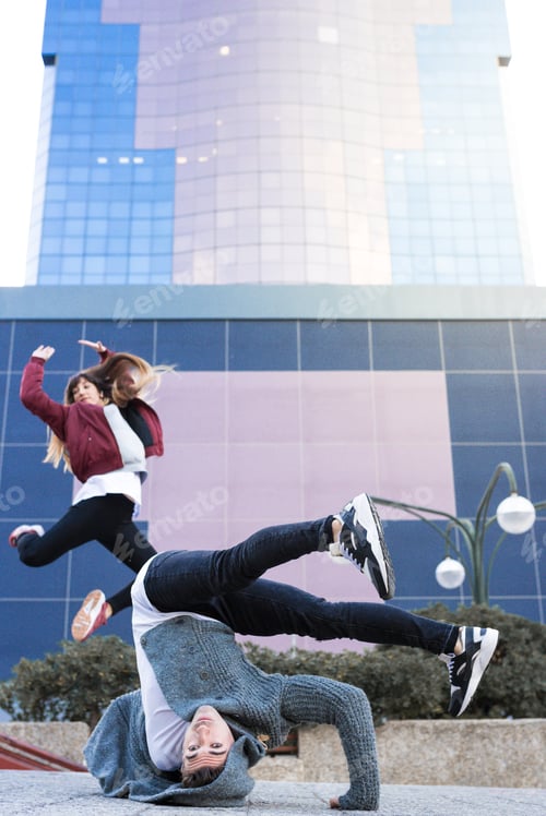 Preview: Young happy couple dancing on the street